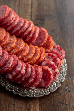 Smoked sausages on a silver tray.