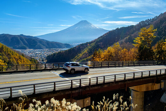 Mount Fuji with blurred cars driving on the road in Autumn, Japan.
