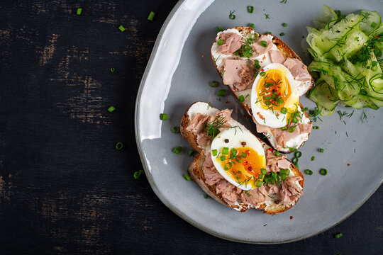 Gourmet Tuna Toasts with Soft Boiled Eggs on Artisan Bread. Top view