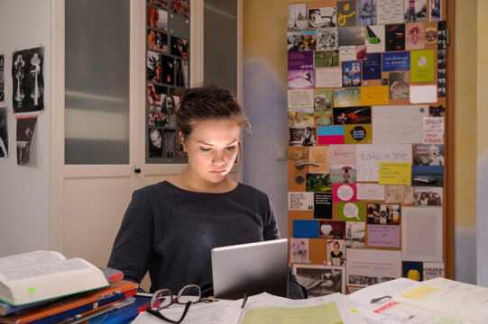Female pupil doing homework with digital tablet