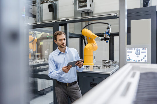 Businessman, working in high tech company, using digital tablet