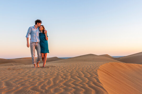 Affectionate couple walking in the dunes at sunset, Gran Canaria, Spain