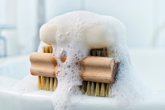 Soap, foam and brush on bathroom sink