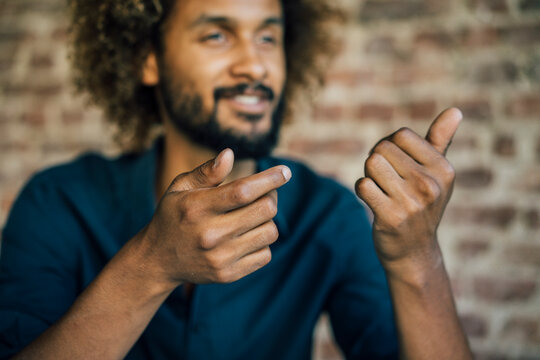 Man with beard and curly hair gesticulating