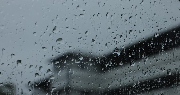 Raindrops and water condensation on a transparent window glass panel