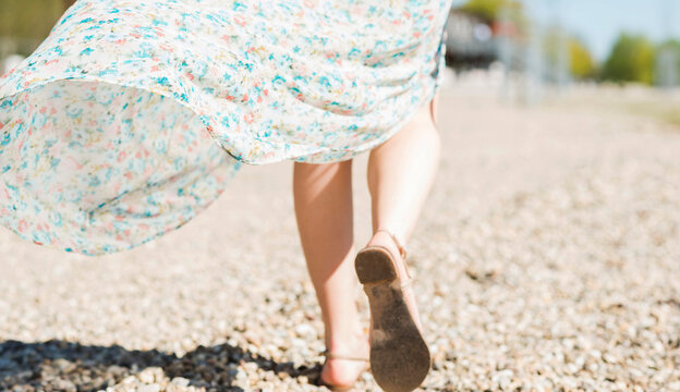 Woman walking on shingle beach