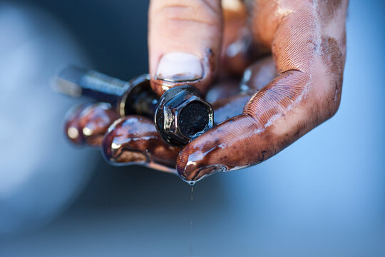 Mechanic's hands holding screw
