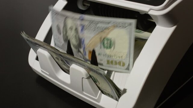 Money counting machine with motion bills. Money counting process. Paper money in counting machine. Business and finance concept with money. UDS in motion. Investment with cash dollars.