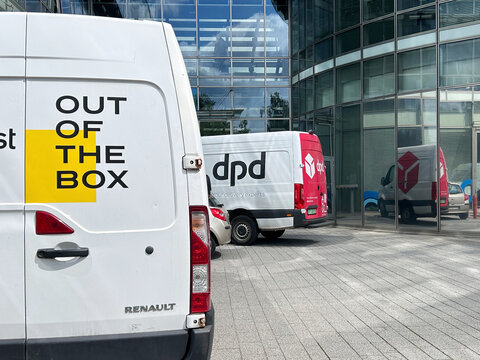 Courier vans from DPD and InPost parked outside a modern office building, representing parcel delivery, logistics and last-mile shipping services in Gdynia, Poland July 27, 2026