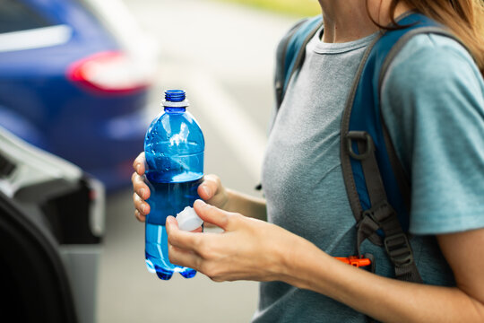 Woman Holding Water Bottle Before Summer Hike to Stay Hydrated in Hot Weather
