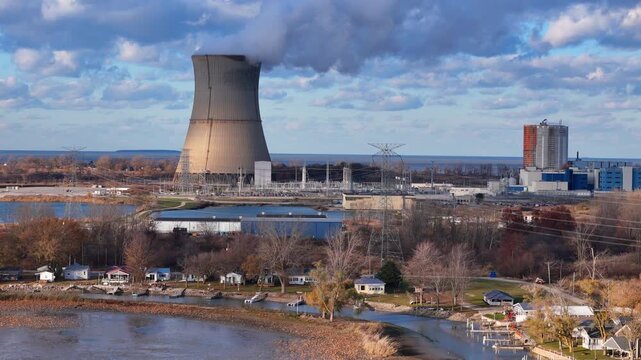 Davis-Besse Nuclear Power Plant releasing steam from its cooling tower near Lake Erie