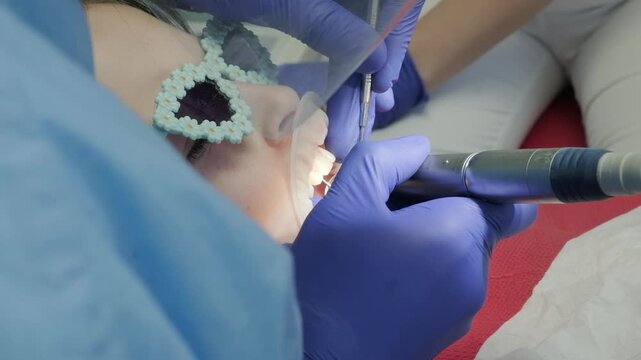 Dentist team performing medical dental procedure on child patient