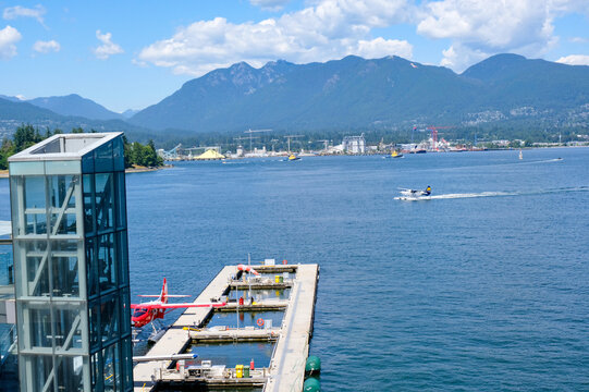 Float Planes Moored at Vancouver Harbour Flight Centre with Stanley Park and North Shore Mountains in Vancouver, Canada