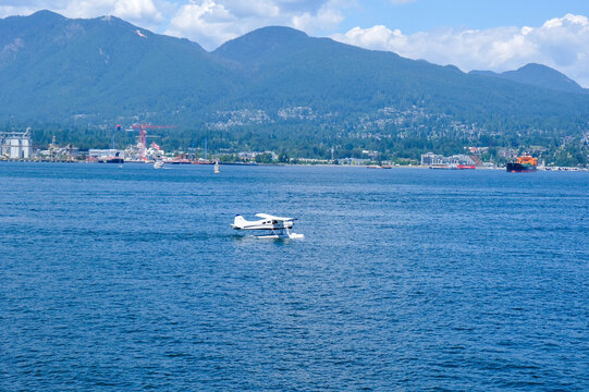 Float Planes Moored at Vancouver Harbour Flight Centre with Stanley Park and North Shore Mountains in Vancouver, Canada