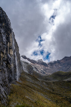 Waterfall cascading from snowy mountains on the Laguna 69 trek, Peru