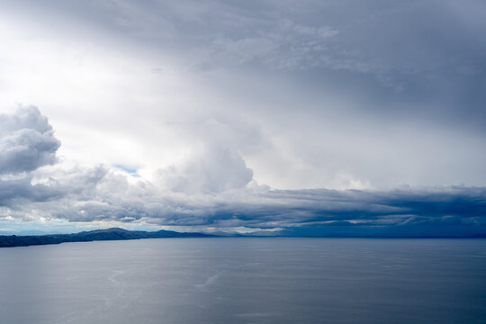 View of Lake Titicaca from Amantani Island under stormy clouds