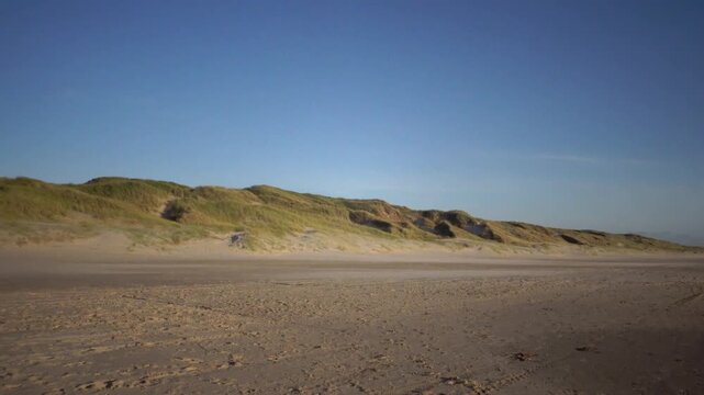 Hirtshals, Denmark A North Sea beach and dune landscape with grasses at sunset.  