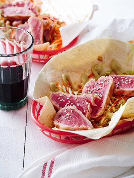 Seared tuna tacos with cabbage slaw and sesame seeds, vibrant food truck menu, modern dining concept