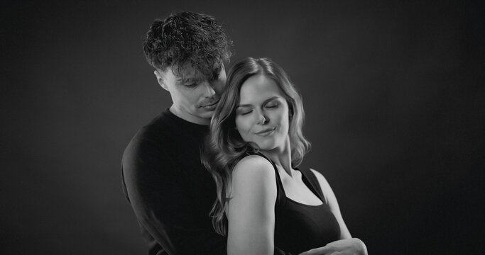 Happy couple embracing with love and closeness in a studio portrait