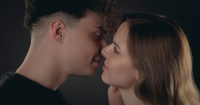 Young couple looking at each other closely, sharing a moment of romance and affection
