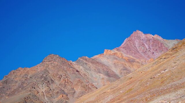 Landscape shot of dry Himalayan mountain peak against the blue sky during the autumn season as seen near Kargyak village in Zanskar Valley of remote Ladakh, India. Scenic natural background.