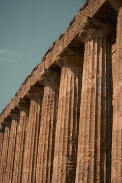 Low angle perspective of doric columns in ancient stone at Agrigento temple