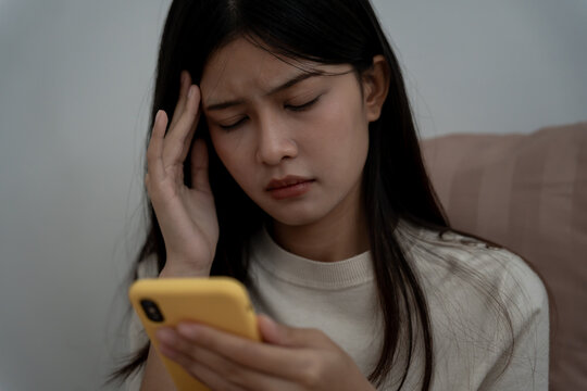 Eye problems, Asian women use hand cover eyes due to eye irritation, eye rubbing, dry, eye pain after look mobile phone long time, migraine, headache, blurred vision, photophobia, small words