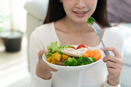 Diet and dieting, enjoy eat. Healthy woman hold salad food and feeling happy. Beauty slim female body achieves weight loss goal for healthy life, crazy about thinness, thin waist, nutritionist.