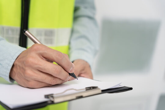 inspector or engineer is inspecting construction and quality assurance new house using a checklist. Engineers or architects or contactor work to build the house before handing it over to the homeowner