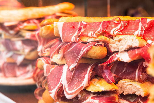 Spanish bocadillos with Iberian ham displayed in a shop window