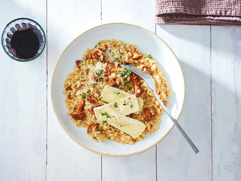 Creamy risotto with mushrooms and parmesan, rustic dining experience, culinary delight for upscale menus
