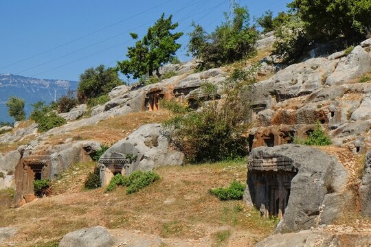 Ancient Lycian rock tombs carved into limestone cliffs at Myra archaeological site near Demre, Turkey