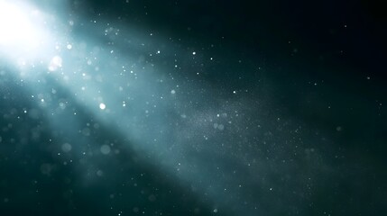 Obraz premium A radiant beam of light illuminates suspended particles against a dark background creating an ethereal and serene atmosphere