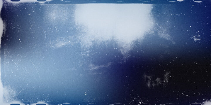Vintage film grain texture with blue light leak and dusty scratched overlay abstract background photography