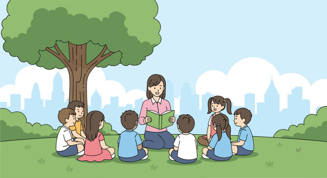 Female teacher sits on the grass in a city park and reads an open book to a group of listening young students.