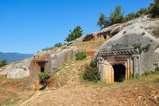 Ancient Lycian rock-cut necropolis with carved tombs in limestone hillside at Myra archaeological site, Turkey