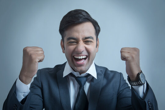Smiling businessman making fist