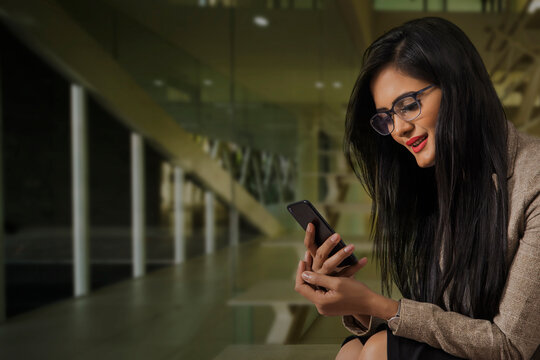 Businesswoman using cell phone in office