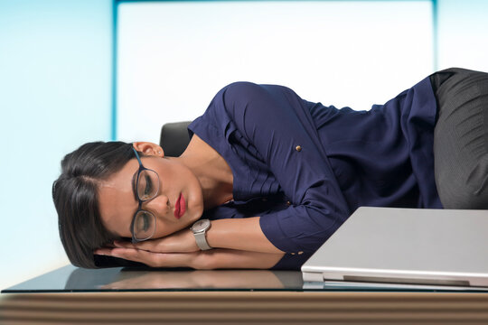 Businesswoman sleeping at desk in office