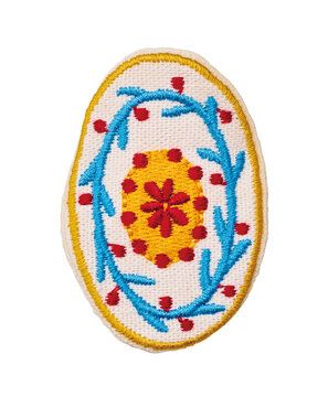 Oval embroidered patch with folk floral pattern in yellow blue and red