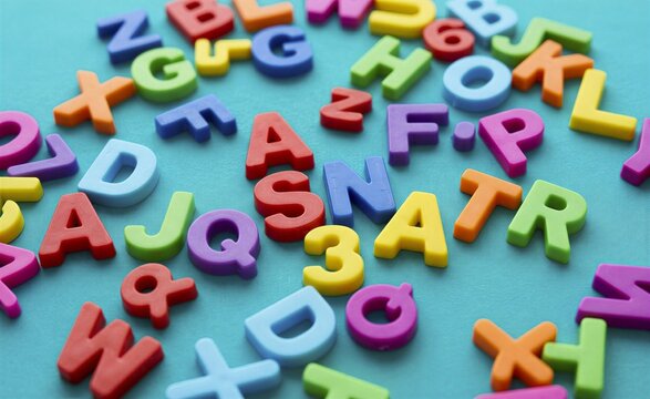 Alphabet letters in bright plastic are scattered across a textured blue surface to inspire creative learning.