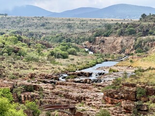 Fototapeta premium Bourke's Luck Potholes near Graskop, Mpumalanga, South Africa, featuring rocky outcrops and a wooden bridge