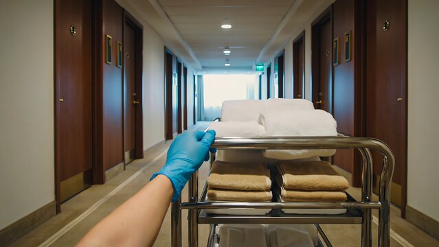 Hospital corridor with patient stretcher and healthcare worker transporting medical bed
