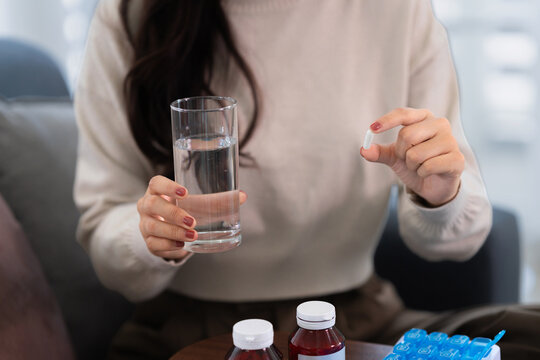 woman take or eat medical pill for treatment healthcare