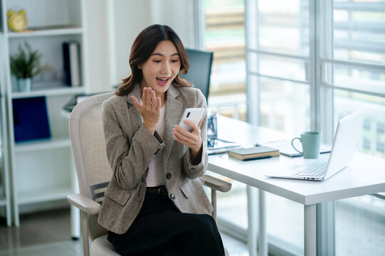 excited business woman watching on mobile phone read a good news