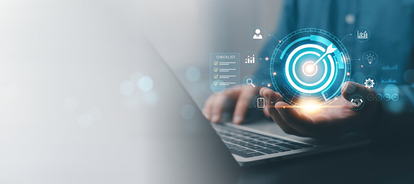 Business goal achievement concept with digital target, checklist and analytics on laptop, illustrating strategic planning, performance management, success, growth, productivity, measurable results.