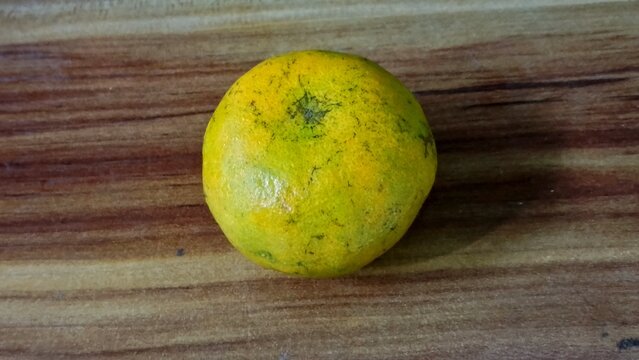 Single Fresh Orange Fruit on Wooden Table Background