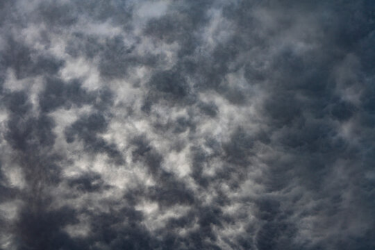 Dramatic dark storm clouds abstract background. Heavy grey storm clouds filling the sky before rain, creating dramatic, moody abstract texture of overcast weather