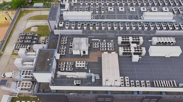 Massive data center rooftop with numerous cooling units for ai and gpu computing. Aerial establishing shot showcasing the energy infrastructure