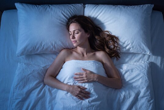 Young woman sleeping peacefully in bed at night